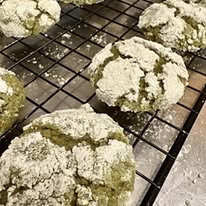 Powdered crinkle cookies cooling on a rack